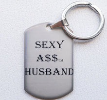 Load image into Gallery viewer, &quot;THE TAGGER&quot; SEXY A$$ HUSBAND CHARM/KEYCHAIN
